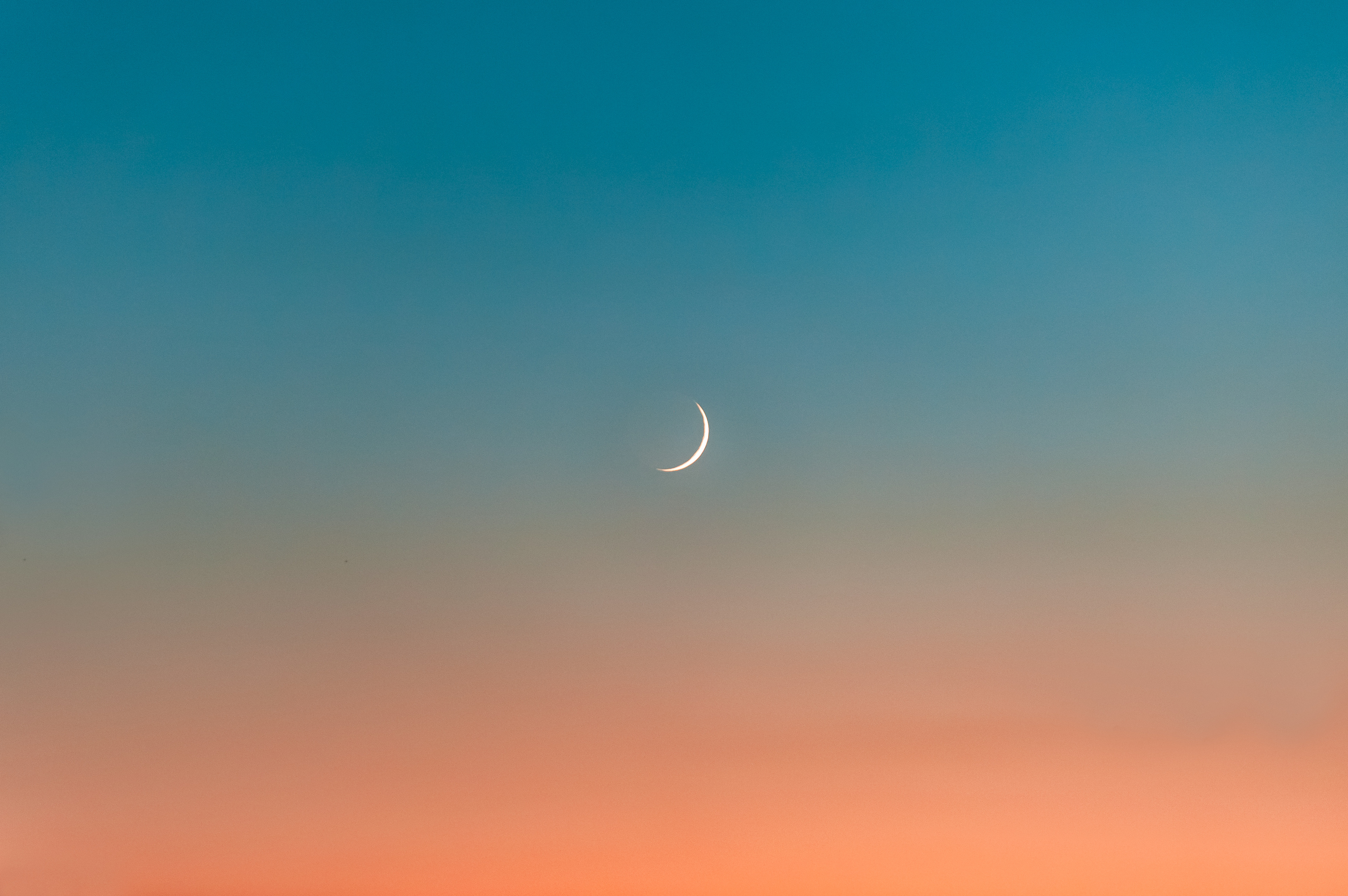 Crescent Moon in the Blue and Orange Sky